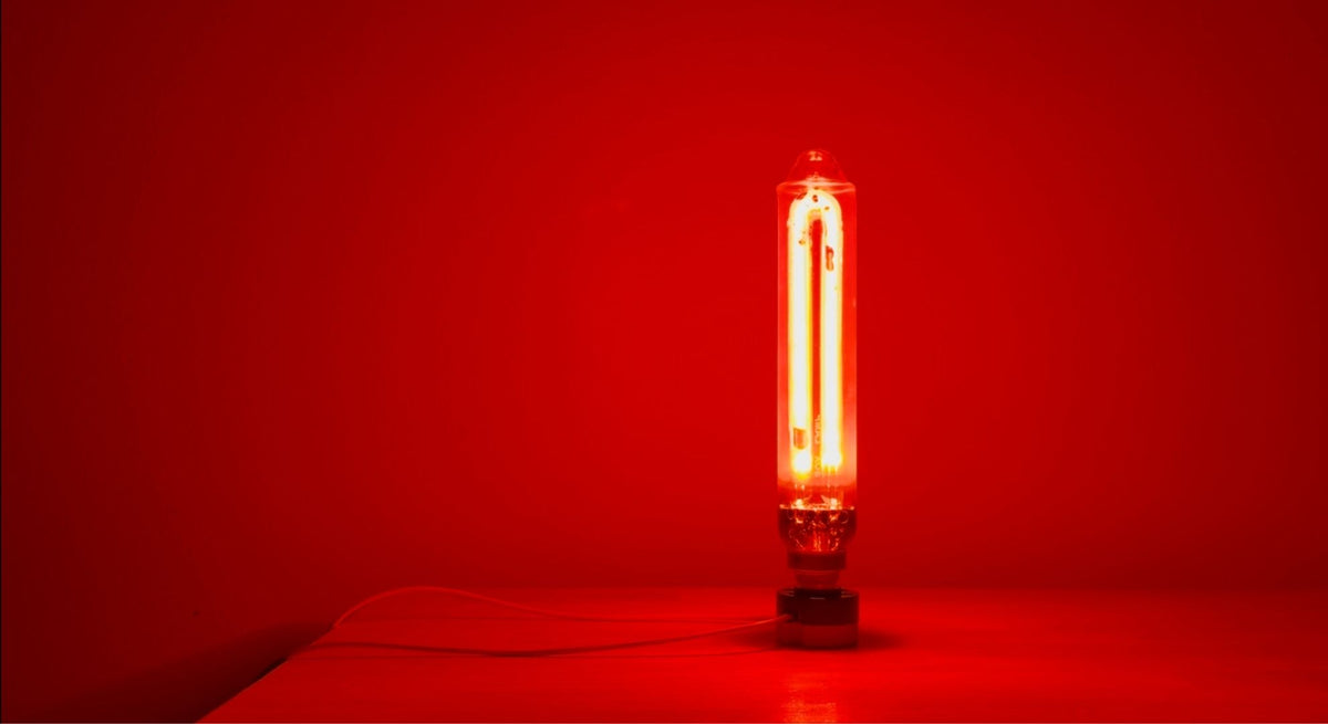 Sox lamp with pink ignition light mounted on a small dark base.